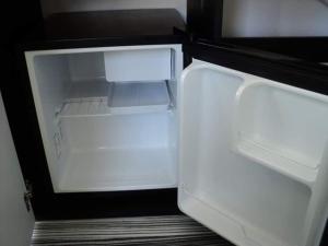 an empty refrigerator with its door open in a room at Деси Къща за гости 1 in Chernomorets