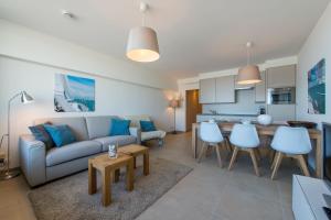 a living room with a couch and a table at Cosy Studio with Sea View in Ostend in Ostend