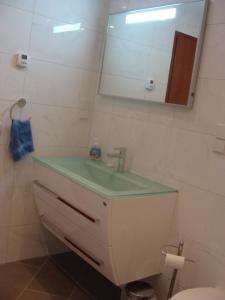 a bathroom with a sink and a mirror at VIP Apartment Baden-Baden in Baden-Baden