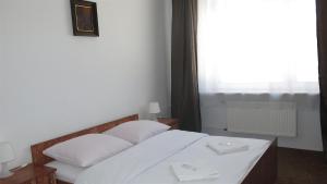 Postel nebo postele na pokoji v ubytování Hotel Olimpijski