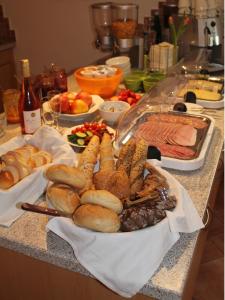 a table with a bunch of food on a counter at Winzerzimmer - Weingut Tinhof in Eisenstadt