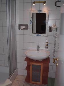 a bathroom with a sink and a mirror at Schlosshotel Bredenfelde in Bredenfelde