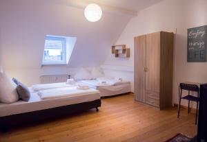 a bedroom with two beds and a cabinet in it at dingdong koblenz - city apartments in Koblenz