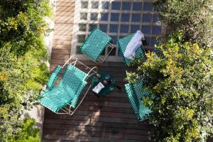 an overhead view of two chairs and a table in a garden at Hotel Casa Bonay & Spa in Barcelona