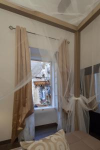 a bedroom with a window with curtains in a room at Your Apartment in Il-Furjana