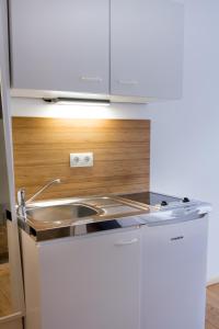 a kitchen with a sink and a counter top at dingdong koblenz - city apartments in Koblenz