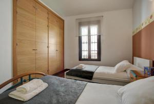 Łóżko lub łóżka w pokoju w obiekcie Holiday House Tenorio