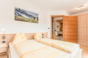 a living room with a large white couch with pillows at Appartements Sonneck in Funes