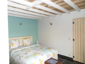 1 dormitorio con cama y pared azul en B&B 'Het Logiement, en Sint-Maria-Lierde