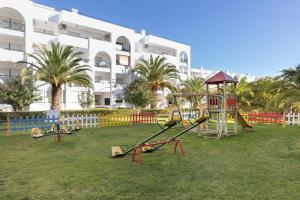 a playground in a park in front of a building at Ukino Terrace Algarve Concept in Armação de Pêra