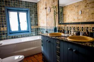 a bathroom with two sinks and a tub and a window at Monte Soalheiro in Zambujeira do Mar +62 photos