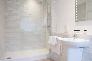 a white bathroom with a sink and a shower at Toby Carvery Doncaster by Innkeeper's Collection in Doncaster