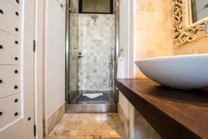 a bathroom with a sink and a shower at Faro Capo Spartivento in Chia