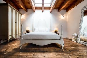 a bedroom with a white bed and two lamps at Faro Capo Spartivento in Chia