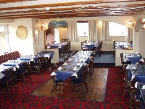 a dining room with blue tables and chairs in it at The Windsor in Haverfordwest