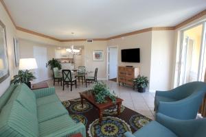 a living room with a couch and a dining room at Vacation Village at Weston in Weston