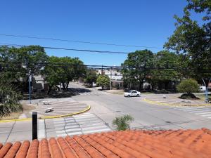 a view of a street with a white car on the road at Departamento Reconquista in Villa María