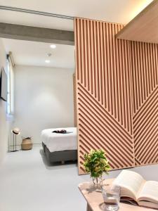 a bedroom with a bed and a table with a book at Inside Bilbao Apartments in Bilbao