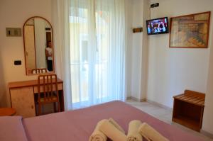 Postel nebo postele na pokoji v ubytování Hotel Garisenda