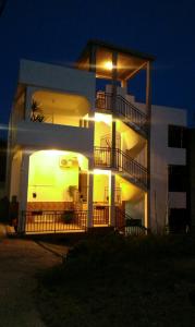 a large white building with lights on the side of it at Guesthouse Marko in Becici