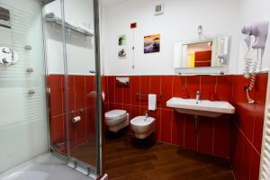 a bathroom with a toilet and a sink and a shower at Una Casa al Belvedere in Enna +58 photos