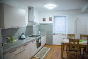 a kitchen with a sink and a table and a stove at Ferienwohnung Steffen in Sankt Wendel