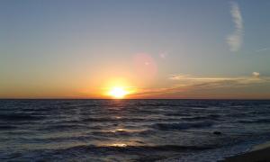 a sunset over the ocean with the sun setting at Miramar Pansiyon in Kaş