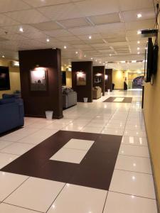 a large lobby with a black and white tile floor at Al Meknan Furnished Units in Medina