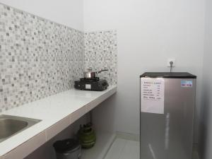 a kitchen with a sink and a refrigerator at Blue Royal Amed in Amed +39 photos