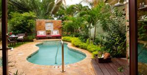 a swimming pool in the middle of a garden at Sandals Negril Beach All Inclusive Resort and Spa - Couples Only in Negril