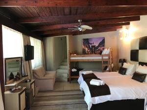 a bedroom with a bed and a couch and a piano at Villa MikaMora in Johannesburg +27 photos