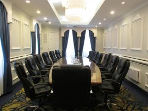 a conference room with a long table and chairs at The Fredericton Inn in Fredericton