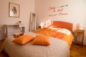 a bed with two pillows and a sign on the wall at Arena Festival in Pula