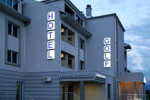 a building with a hotel sign on the side of it at Hotel Golf Luxury in Kruševac