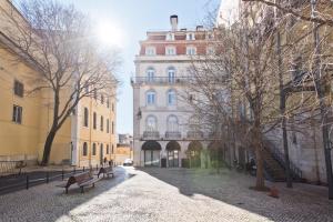 a street with benches and buildings in a city at Libest Chiado 3 - Largo do Picadeiro in Lisbon