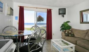 a living room with a couch and a table at Atlantis Motel in Old Orchard Beach