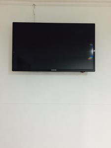 a flat screen tv hanging on a wall at Hotel Parkway Inn 58 Street in Bogotá