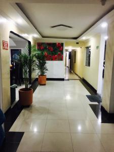 an empty hallway with potted plants in a building at Hotel Parkway Inn 58 Street in Bogotá +16 photos