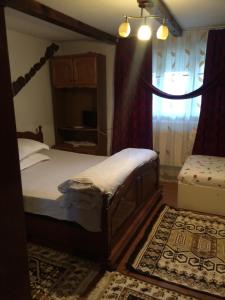 Postel nebo postele na pokoji v ubytování Casa Ionela Petreus
