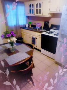 a kitchen with a table and a stove at Apartment Summer in Puerto Peñasco