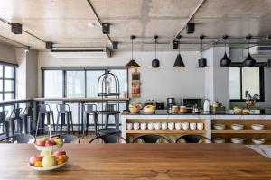 a kitchen with a wooden table with fruit on it at Travelier Hostel in Bangkok