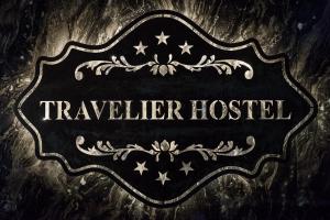 a sign that reads traveler hostel on a wall at Travelier Hostel in Bangkok
