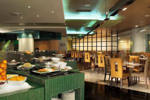 a restaurant with a buffet of food and tables and chairs at Grand Plaza Cheongju Hotel in Cheongju