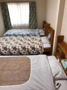 Posteľ alebo postele v izbe v ubytovaní Minshuku Takenoya