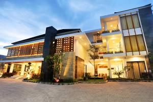 a large building with a courtyard in front of it at Kautaman Hotel in Mataram