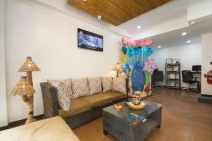 a living room with a couch and a table at Bamboo Beach Resort & Restaurant in Boracay