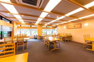 a dining room with wooden tables and chairs at Kasuga Hotel in Nara