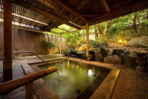 a pool of water in the middle of a garden at Kasuga Hotel in Nara