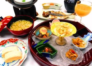 a table with plates and bowls of food and a drink at Kasuga Hotel in Nara