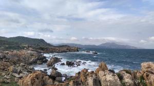 a view of the ocean with rocks in the water at Sun Sea Hotel in Quy Nhon